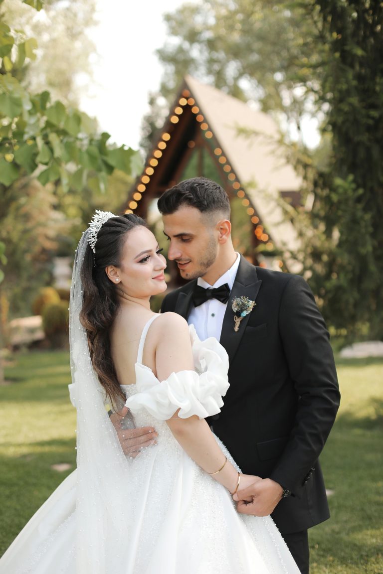 Beautiful bride and groom embracing at a picturesque outdoor wedding venue.